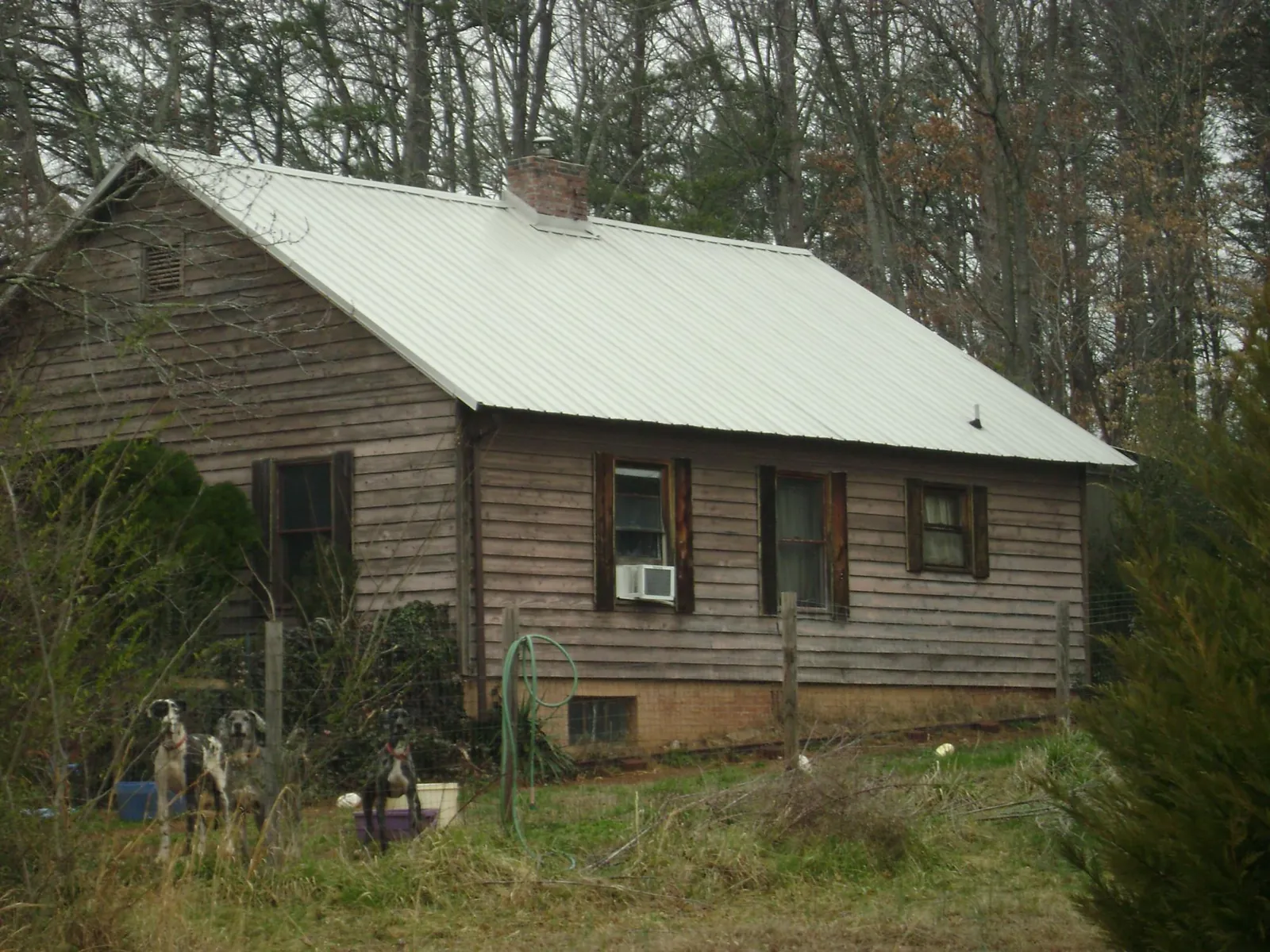 White metal roof on an old wood sided farmhouse, from a Asphalt Shingle Roof Repair job in Loysville